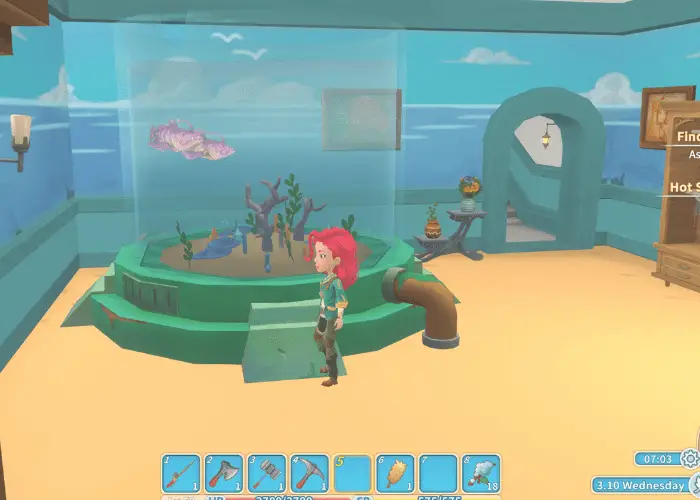 The author's character is by a large fish tank. The shows how to make Money in My Time at Portia by breeding