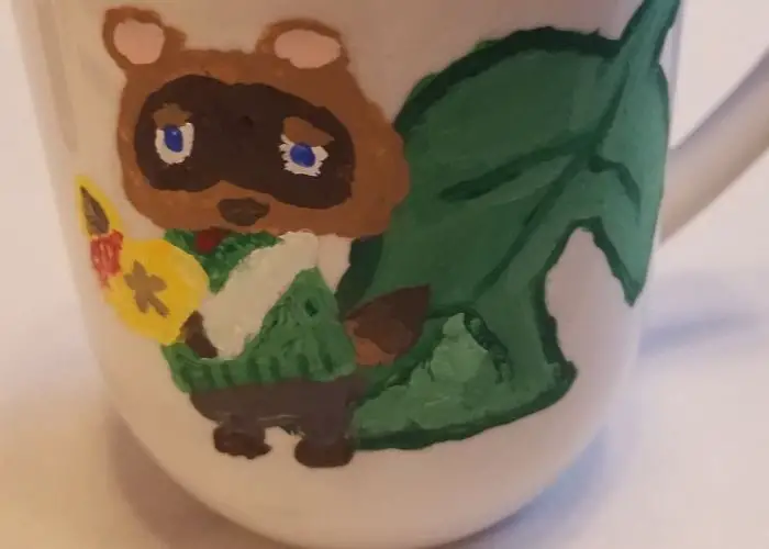 A Tom Nook with the Leaf Icon on a Coffee Mug. A great gift for an Animal Crossing Fan.